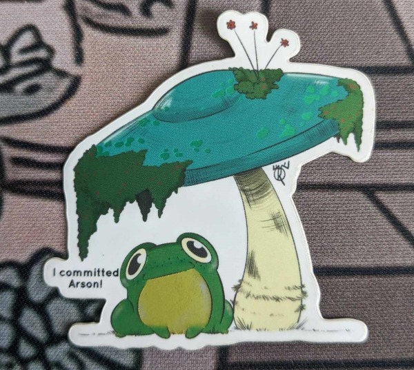 Autocollant grenouille sous un champignon